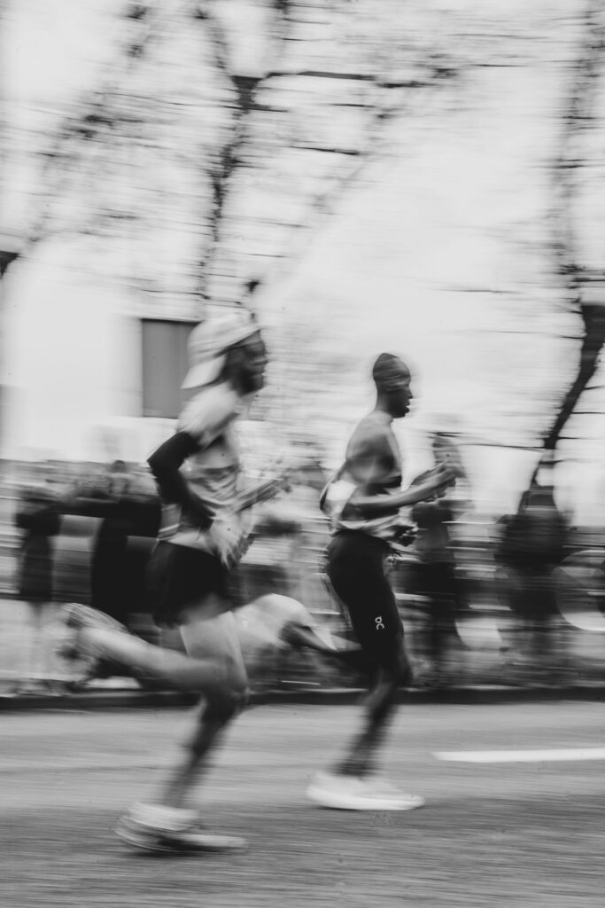 Läuferinnen und Läufer im Rennen auf einer Stadtstraße nach ihrer Halbmarathon Vorbereitung