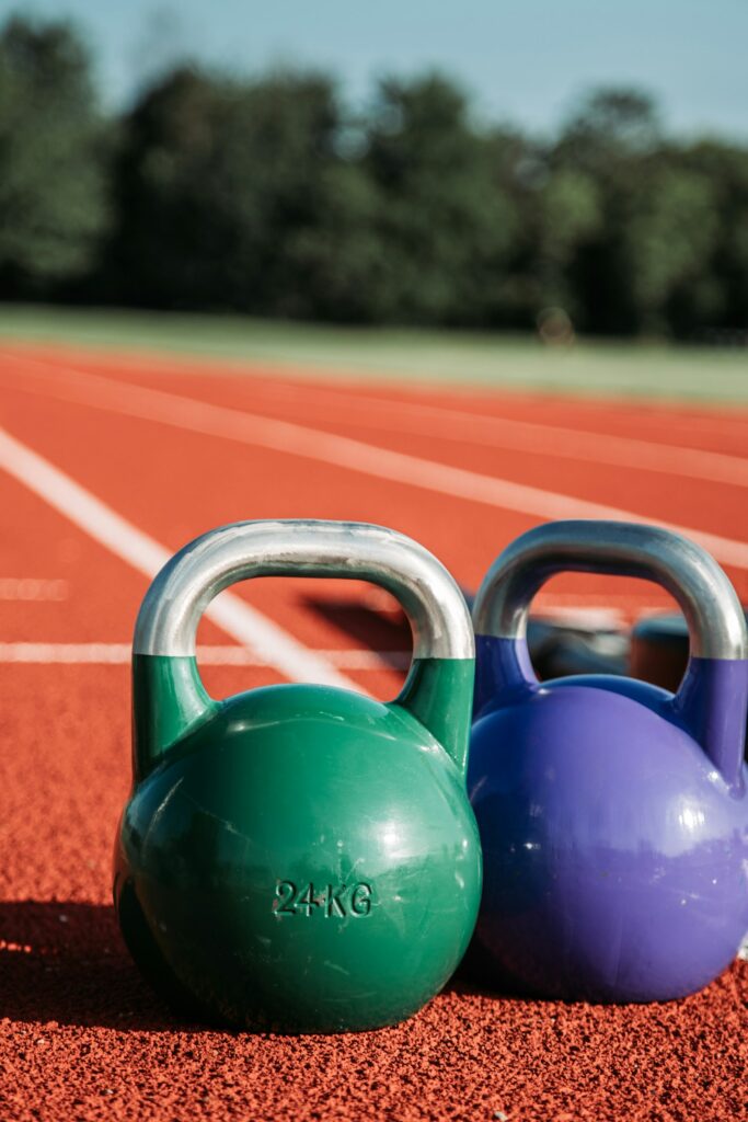 Zwei farbige Kettlebells nebeneinander auf dem Boden